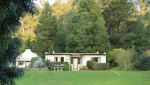 Cranford Country Lodge chalets in tree line (4)